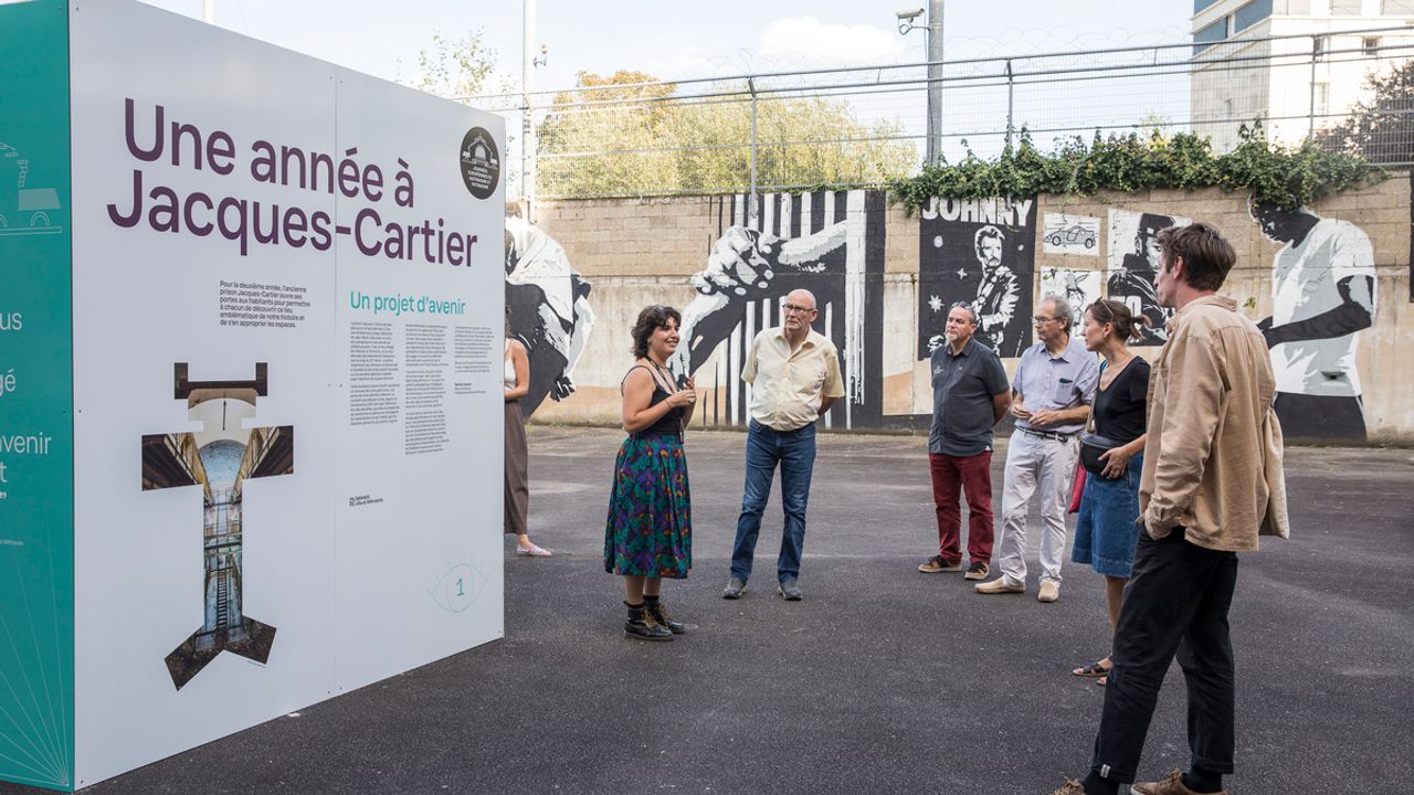 Temps de concertation au sein de la prison, des personnes discutent autour de panneaux d'informations