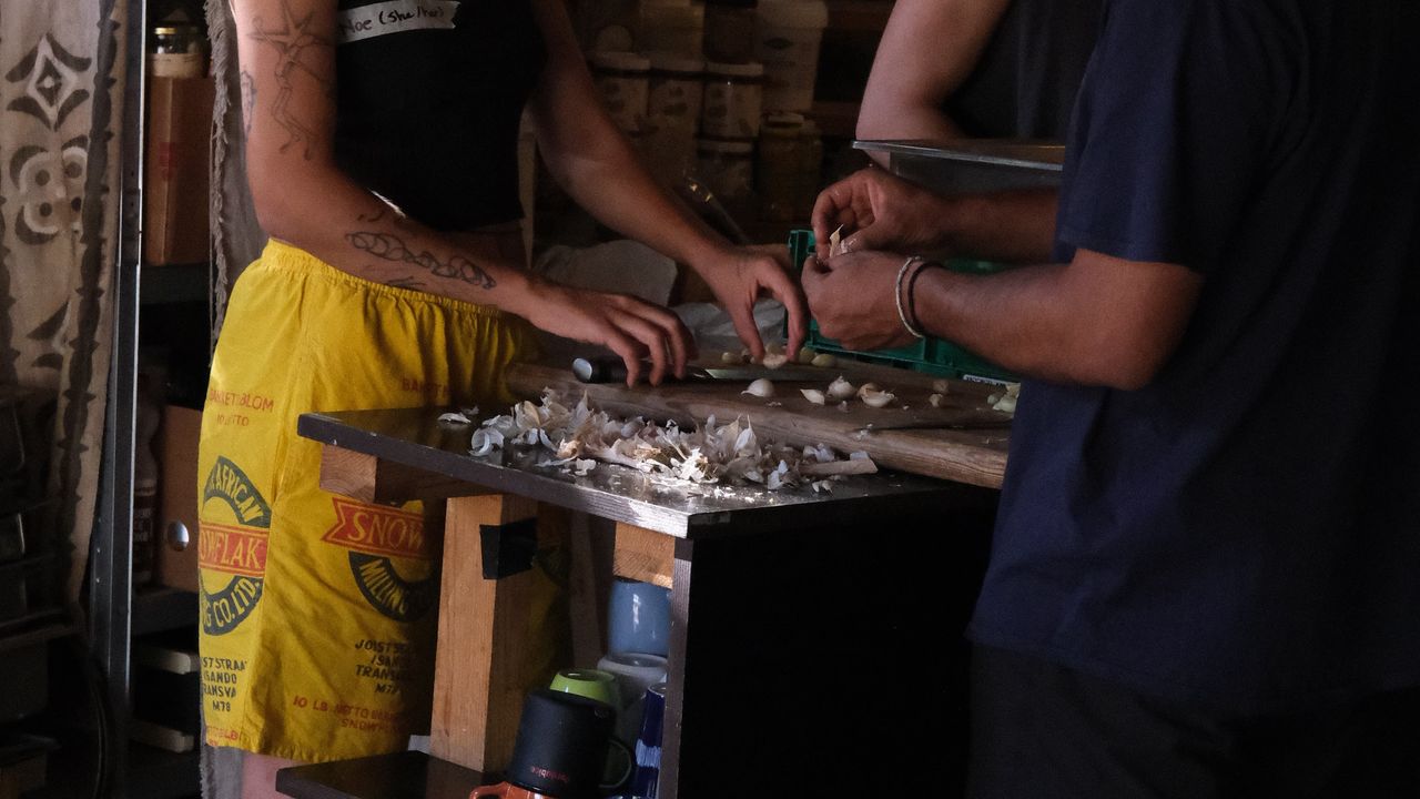 Two people cooking inside