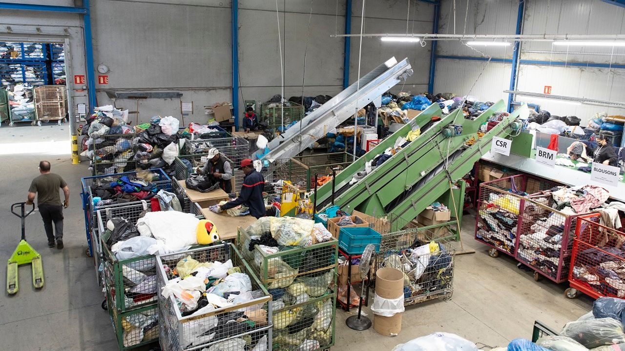 Photos des locaux du relais à Acigné. Sur l'image on aperçoit des gens qui trient les vêtements.