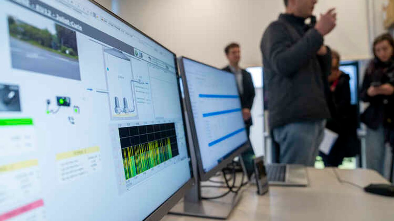 Explications devant des écrans de contrôle.