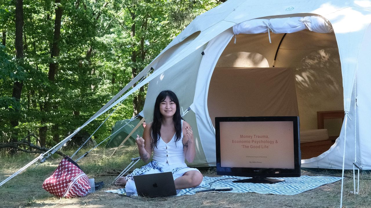 Person sitting outside on the grass giving workshop