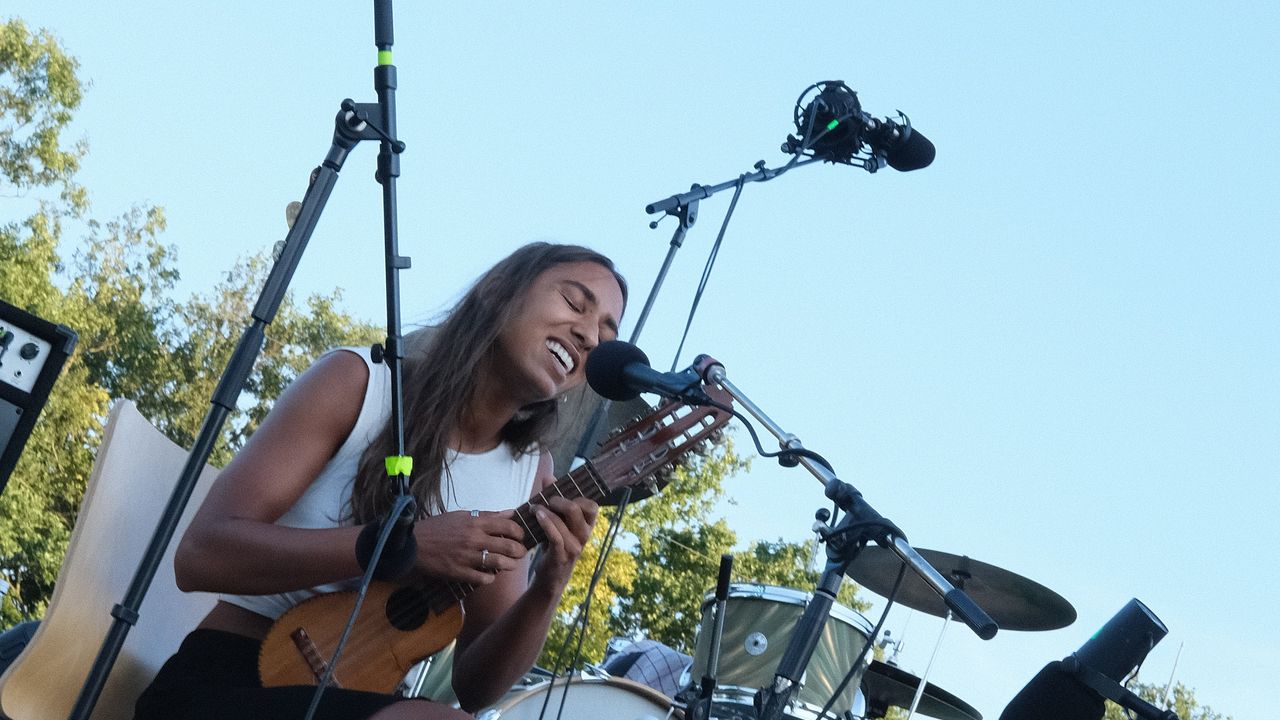Band performing at outdoor stage during the afternoon