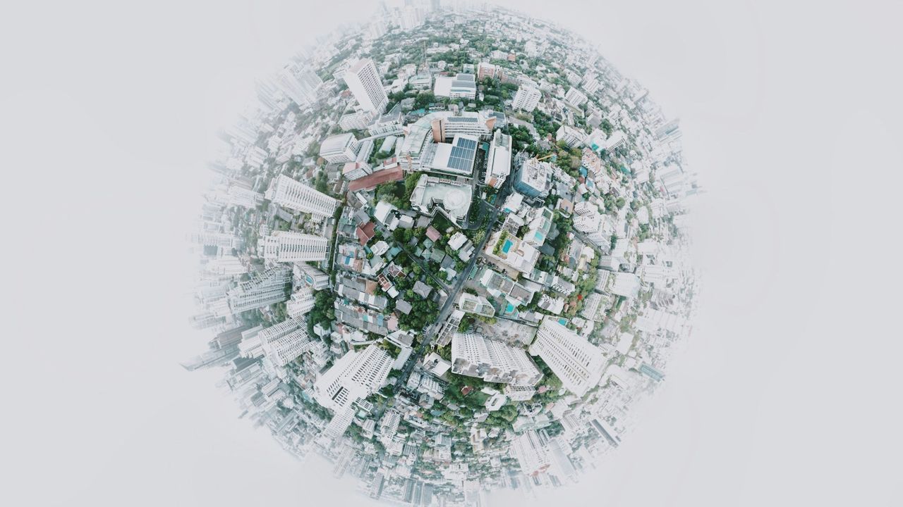 Aerial View of a city wrapped into a circular globe