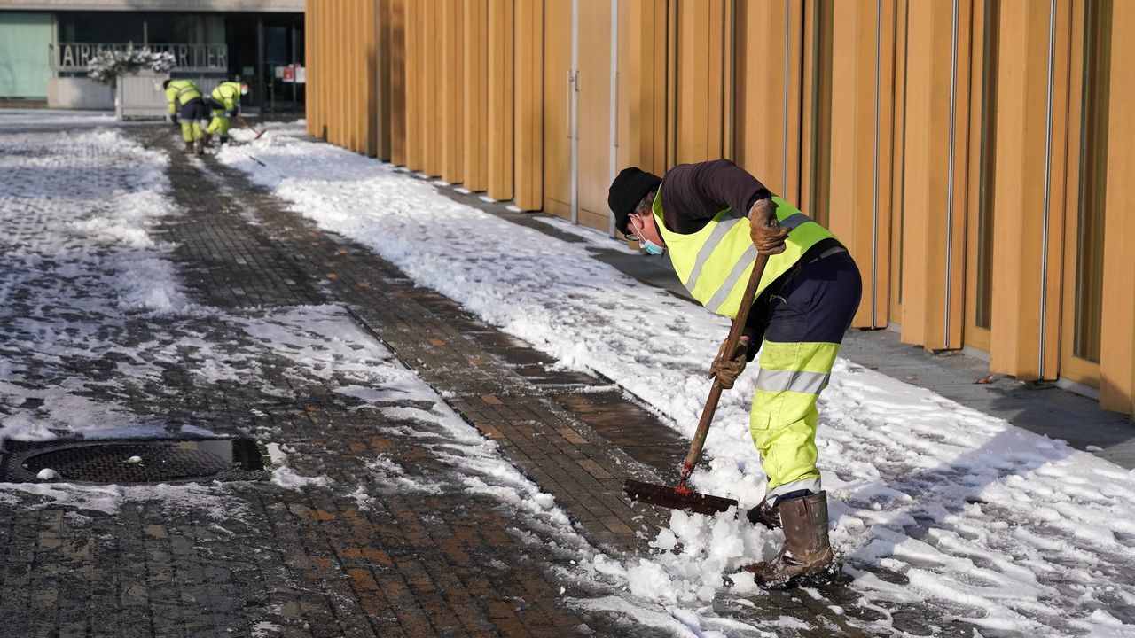agent de Rennes avec une pelle pour dégager la neige de la voirie