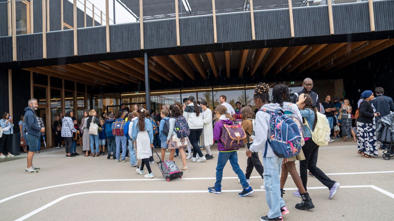 Les enfants sont dans la cour d'école pour leur première rentrée scolaire dans la nouvelle école Miriam-Makeba.