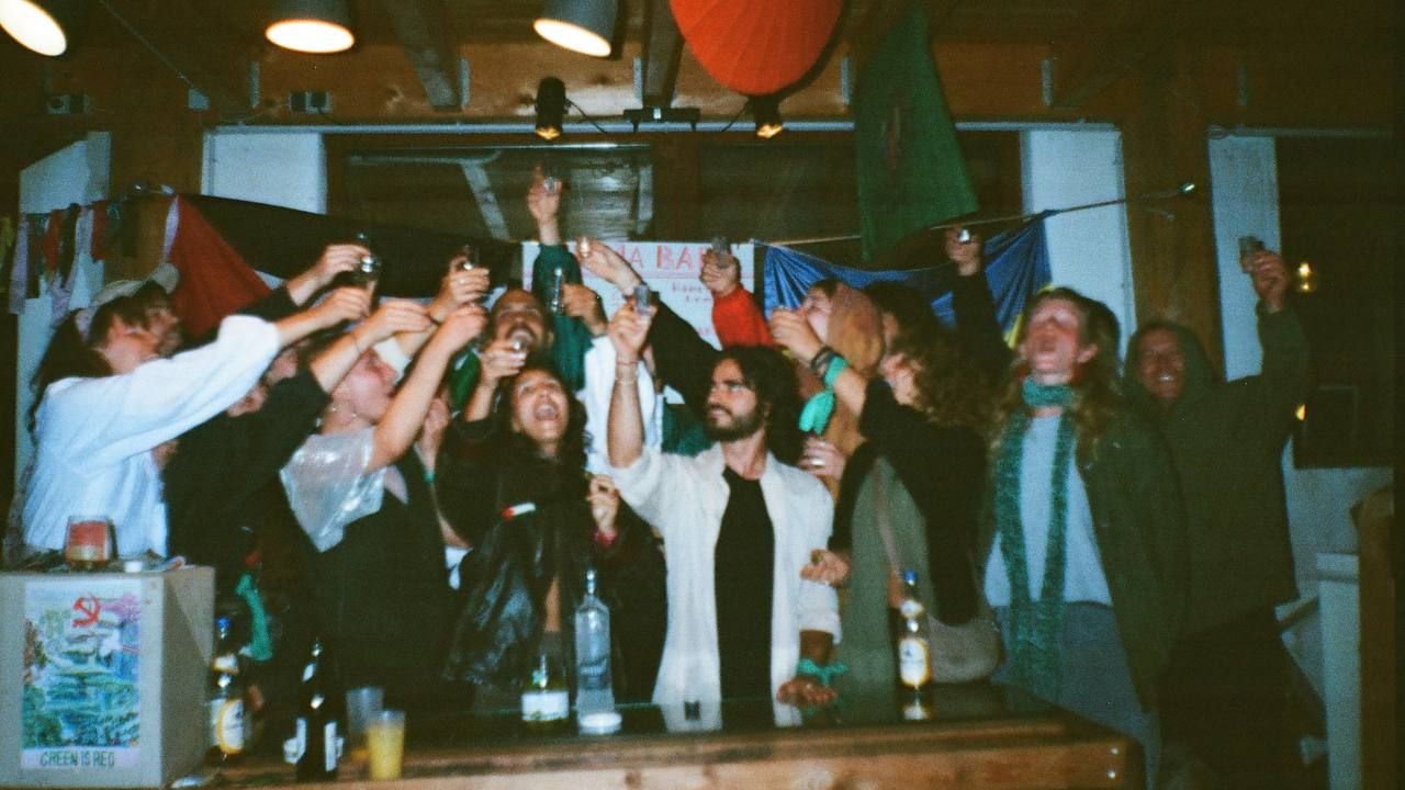 Group of people behind the bar cheering