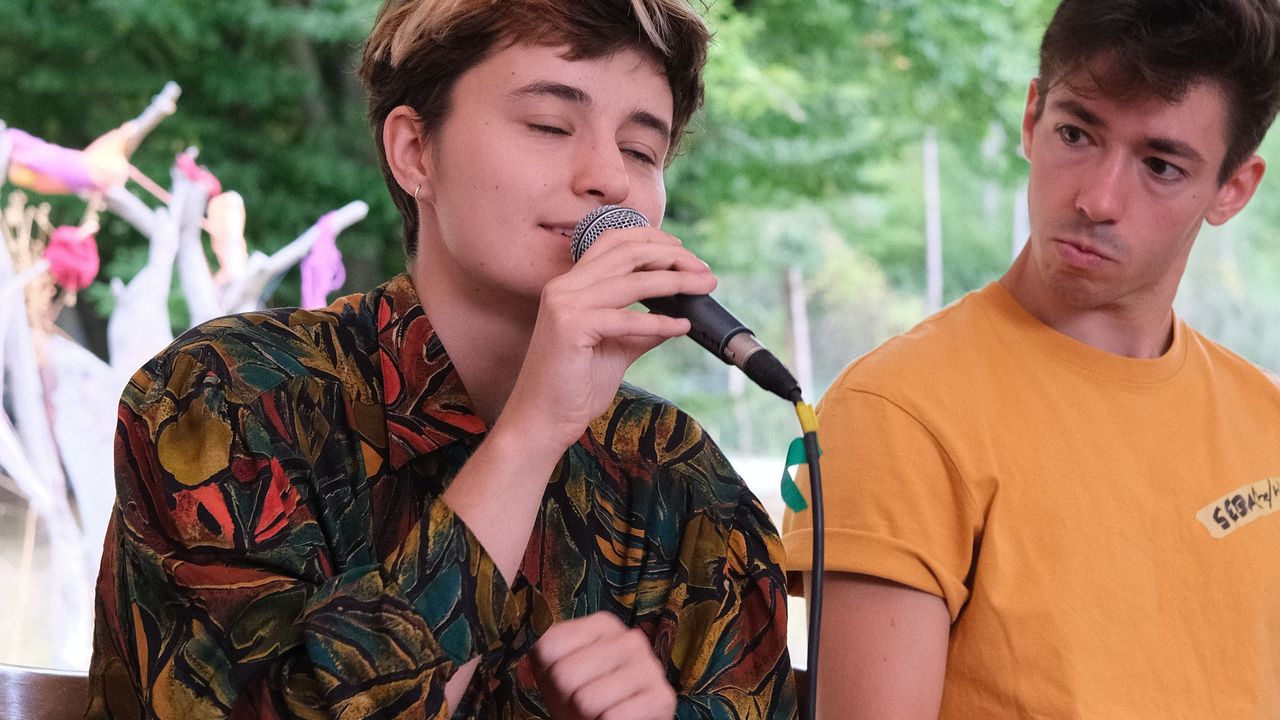 People sitting on a stage talking at a roundtable