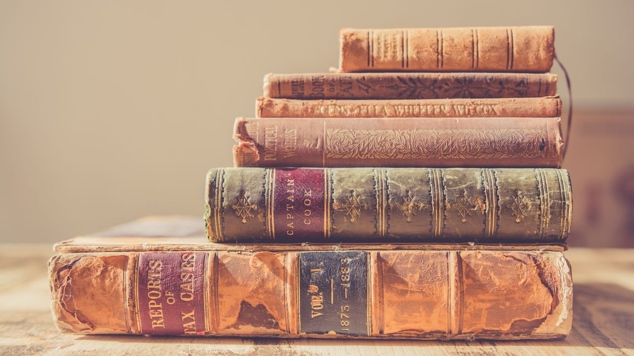 shallow focus photography of stack of books