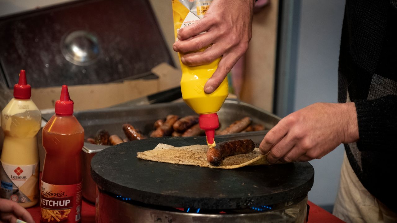 Photo d'une galette saucisse en cours de cuisson sur un billig. 
