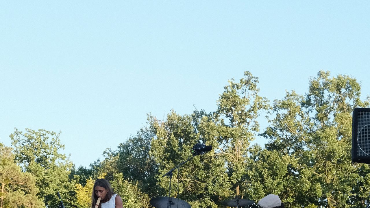 Band performing at outdoor stage during the afternoon