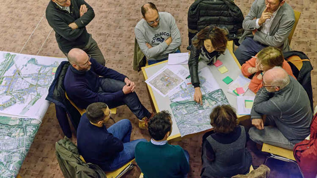 Des habitants sont autour d'une table pour échanger sur une concertation d'aménagement.