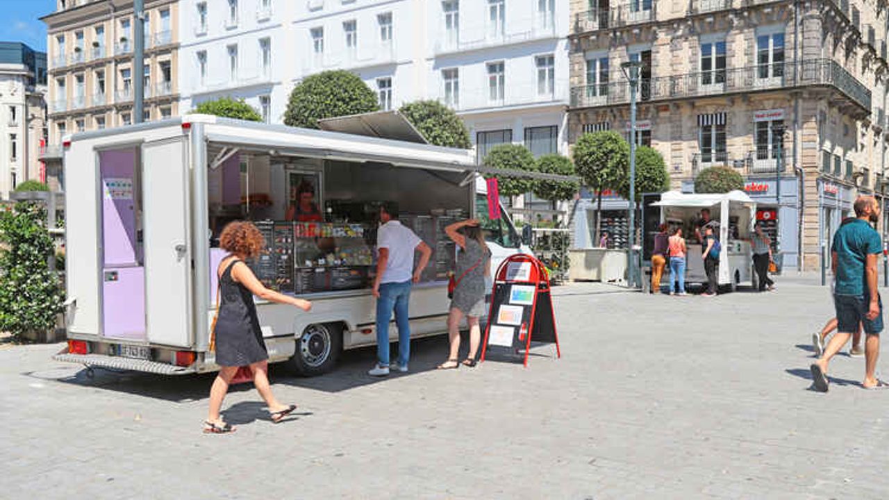 Des clients patientent devant un food truck place de la République.