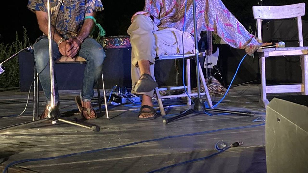 People on stage at night performing for the open mic