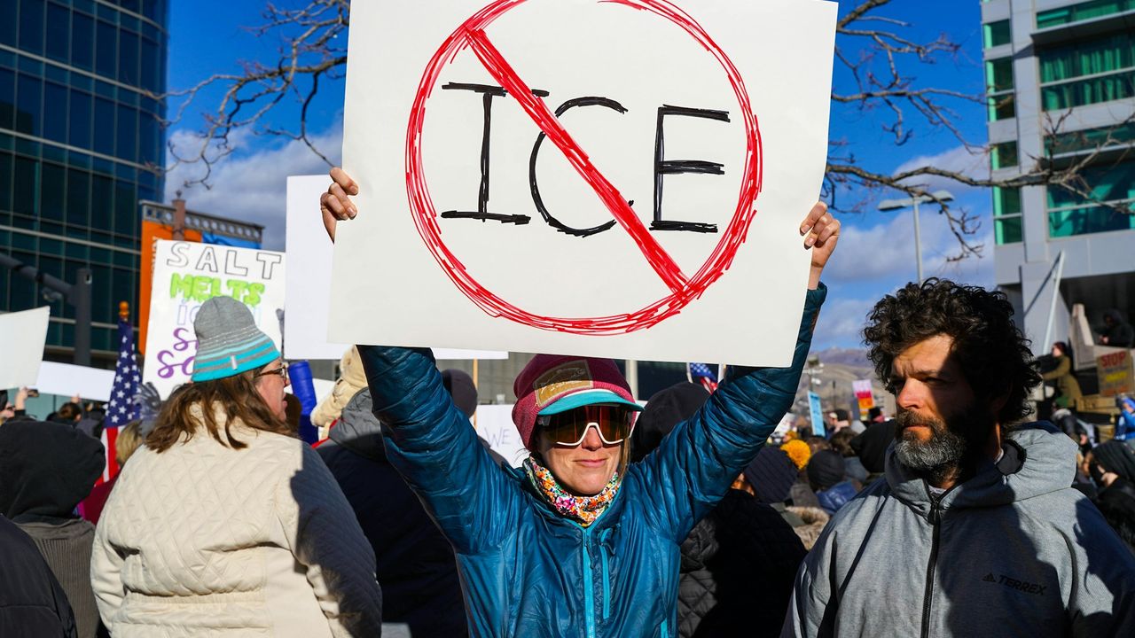 Protestor holding up anti-ICE sign